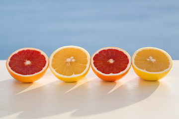 Different colour grapefruits  on sea view background