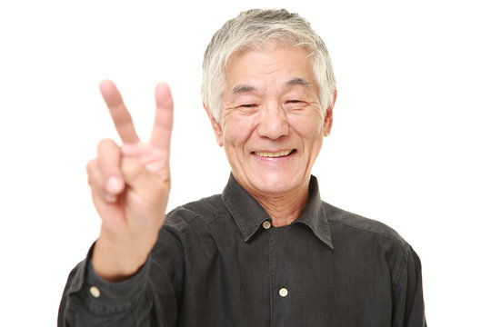 senior Japanese man showing a victory sign 