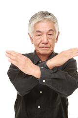 senior Japanese man making NO gesture