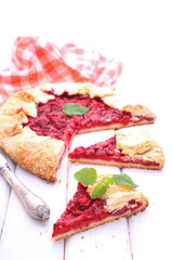 biscuit with strawberries decorated with mint leaf on a white background