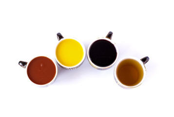 Obraz na płótnie Canvas Four different juices in ceramic cups isolated on white