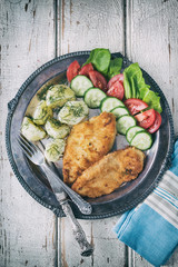 Fried chicken steak,boiled potatoes and vegetable salad 