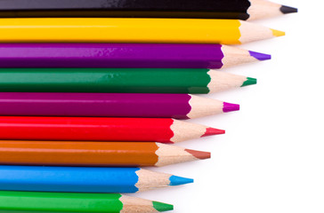 Many different colored pencils on white background