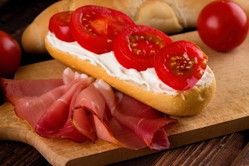 Four tomato slices on fresh baguette