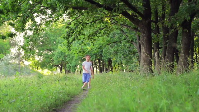 two boys in white clothes running in the park chasing each other