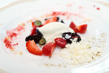 Berries with ice cream on plate
