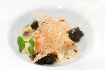 Small gourmet dish with black caviar