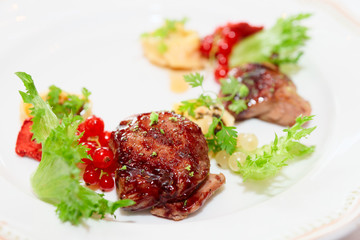 Duck meat with berries and ravioli