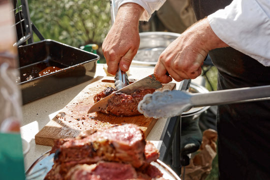 Chef is cutting meat