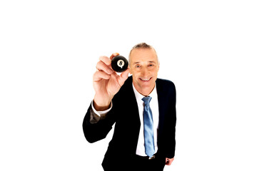 Businessman holding black billiard ball