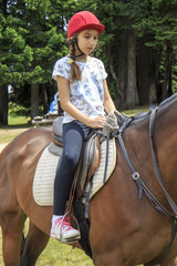 Young girl riding a horse