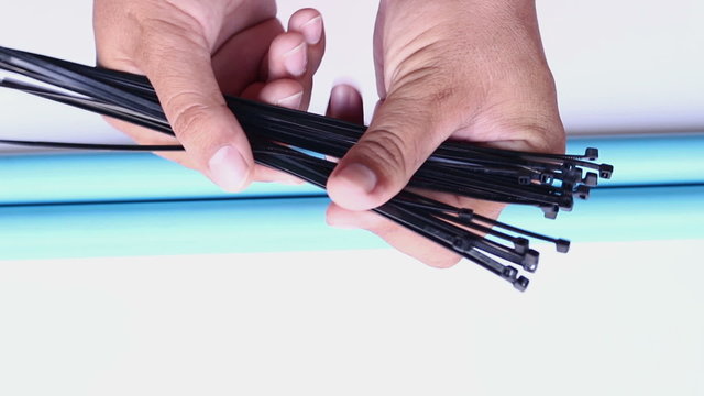 hand locking cable tie on isolated white