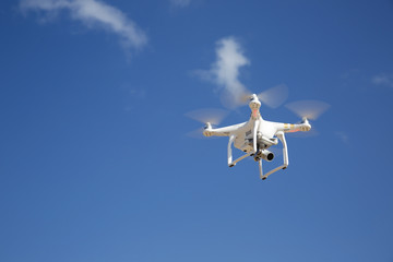 drone flies against blue sky on sunny day - obrazy, fototapety, plakaty