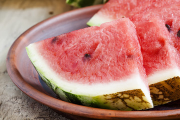 Watermelon slices on a clay plate, selective focus