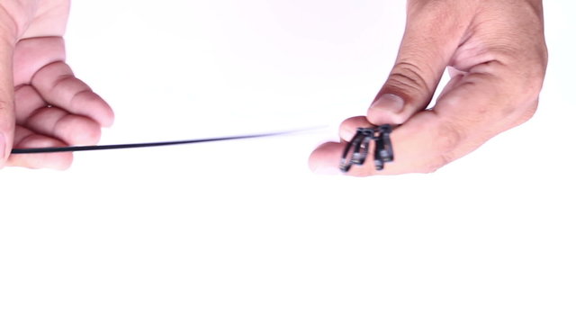 hand locking cable tie on isolated white