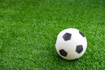 Fototapeta premium Toy ball on artificial grass background