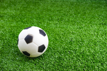 Toy ball on artificial grass background