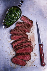 Sliced beef barbecue steak with chimichurri sauce