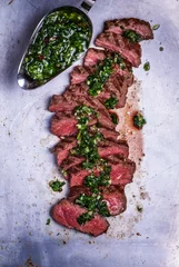 Foto auf Leinwand Sliced beef barbecue steak with chimichurri sauce © tbralnina