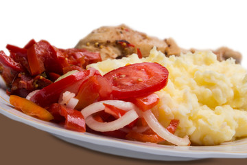 meat, lettuce, tomatoes, peppers and potatoes on a plate