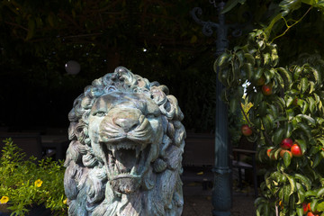 Vintage sculpture of a lion in a garden