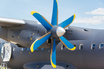 Naklejka na ściany i meble Blue propeller passenger plane close up