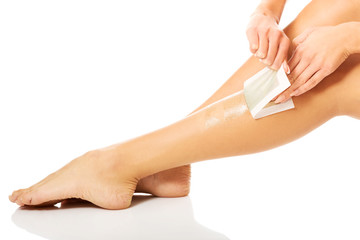 Woman waxing her leg