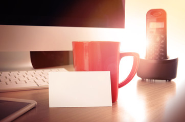 Office desk table with a blank business card. Concept for website contact page and banner, printed material or presentation with company or personal contact informations.