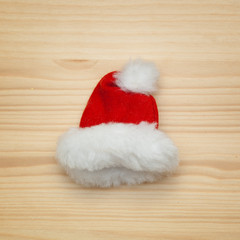 Obraz na płótnie Canvas cap of Santa Claus on a wooden background. Christmas symbol