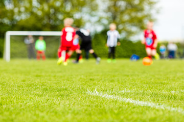 Obraz na płótnie Canvas Blurred kids playing soccer match