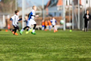 Obraz na płótnie Canvas Blurred Kids Playing Soccer