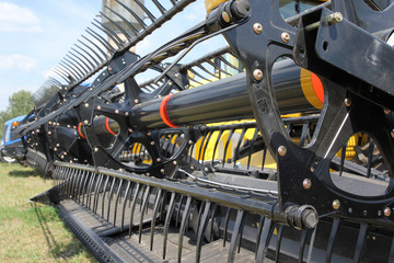 Closeup of harvesting machinery while working the field.