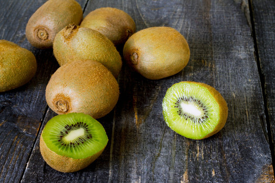 Fresh kiwi on the wooden table, sliced kiwi fruit.