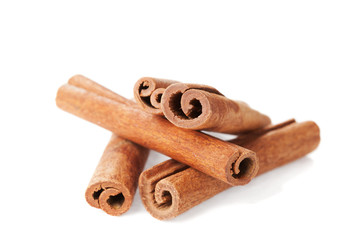 Closeup of cinnamon sticks on white background