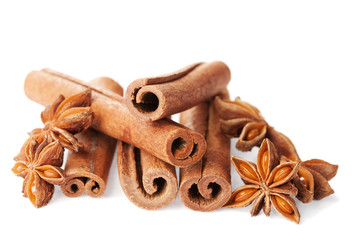 Closeup of cinnamon sticks and anise star on white background