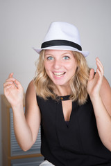 Beautiful young woman wearing summer fedora straw hat