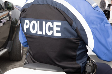back of a police officer jacket with word police written in back