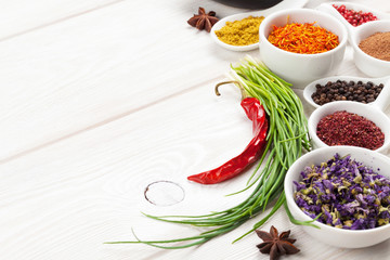 Various spices on white wooden background