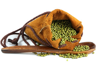 green bean in the leather bag and a spoon on white background.