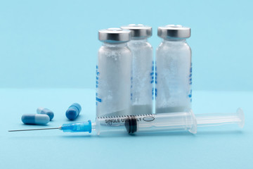 Healthcare and medicine,syringe, pills, medicine bottle on blue