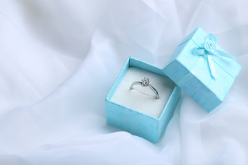 Diamond ring in box on a white cloth