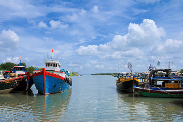 Fishing boats laying in the sea close to the seashore at the main beach of Vung Tau.