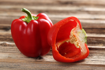 Red peppers on a brown wooden background