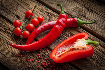 Red hot chili peppers, sweet pepper on wooden table