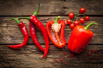 Red hot chili peppers, sweet pepper on wooden table