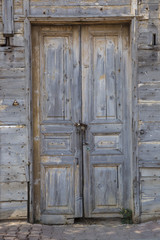 An old door with padlocks on a chain