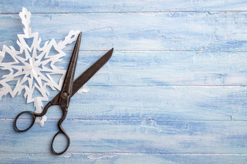 Vintage scissors and paper snowflake at left side