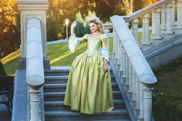 Fototapeta premium Girl royal dress standing steps of the palace.