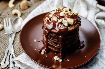 chocolate pancake with bananas, nuts and chocolate sauce