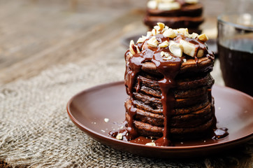 chocolate pancake with bananas, nuts and chocolate sauce